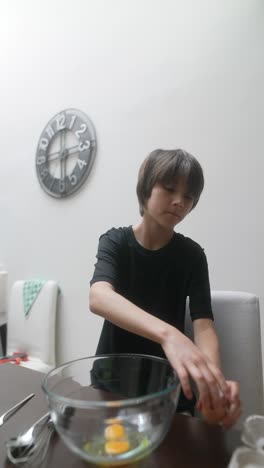 Boy Preparing Eggs for Baking