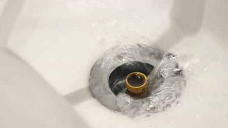 water flowing down a sink drain