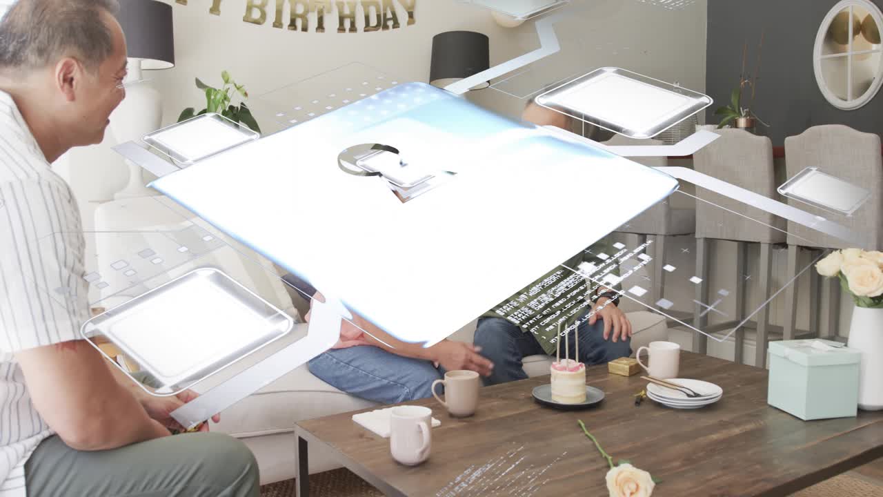Family trio sitting sofa, left man tapping phone causing tech holo overlay hiding cake for birthday