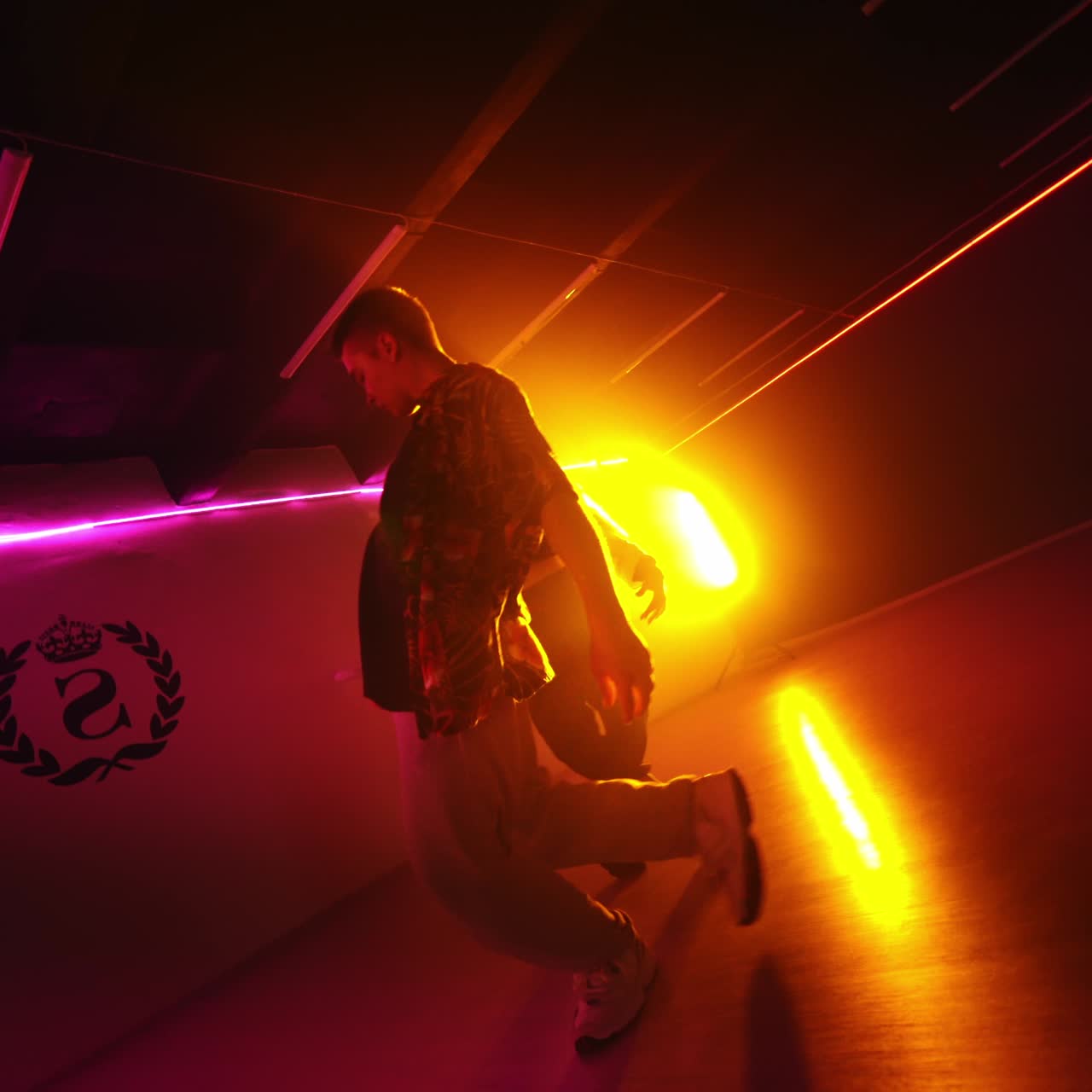 Modern hip hop style dancers moving rhythmically. Dance studio performers at the backdrop of projector