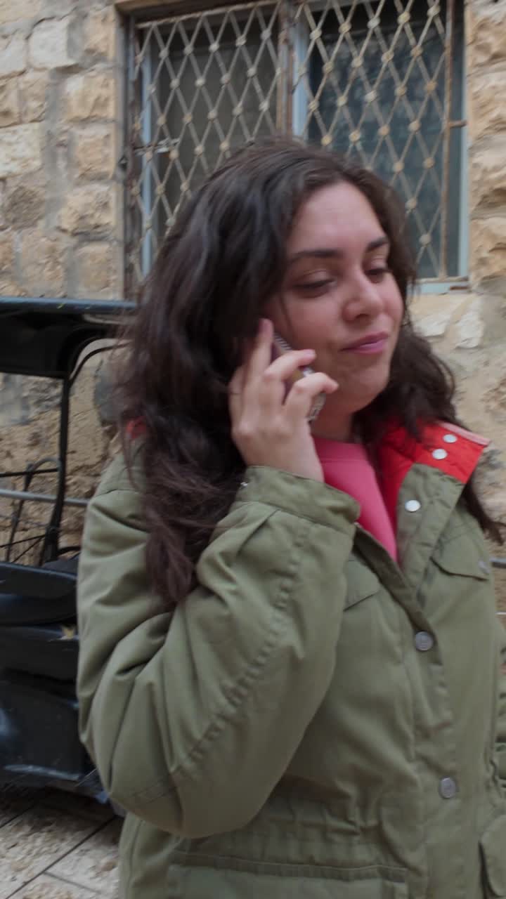 Smiling female traveler having a phone call in a historic location