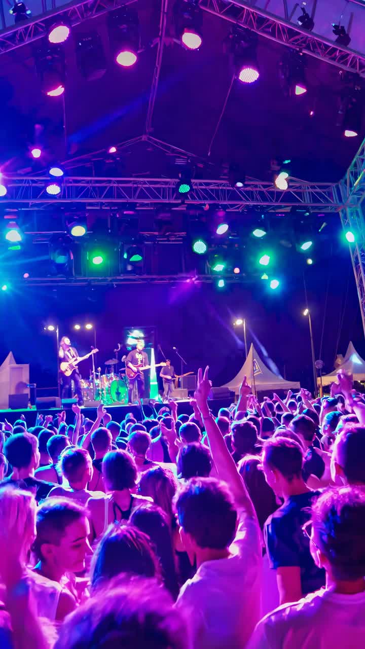 Energetic Crowd Enjoys Live Band Performance at Outdoor Music Festival
