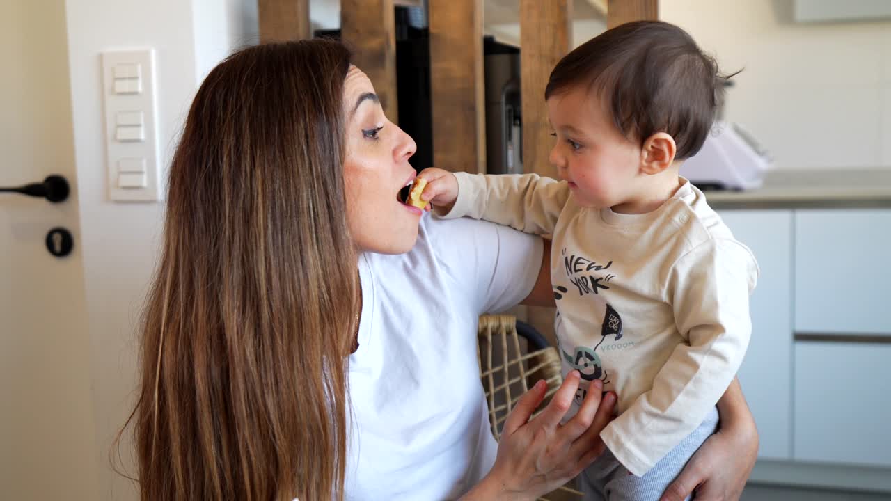 Mother and Baby Eating Together at Home