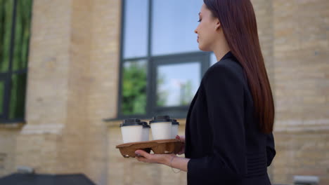 Businesswoman-looking-around-on-street.-Suit-woman-greeting-colleague-outdoors