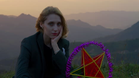 slow motion shot of a model posing holding a star lantern during a mid-autumn festival