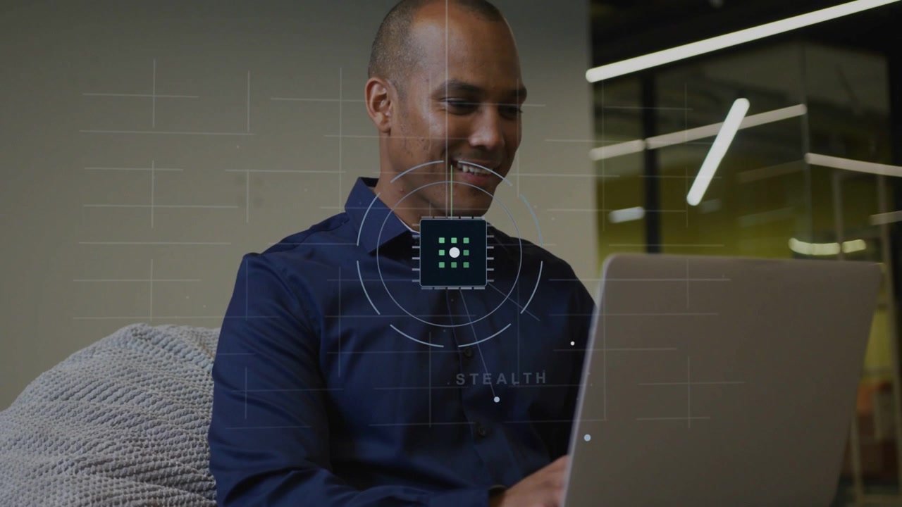Man typing on laptop in lounge, activating tech HUD morphing grid into STEALTH rings for demo