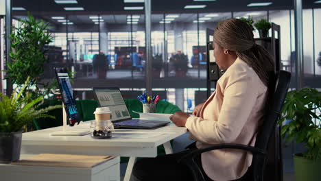 businesswoman working on laptop in modern office