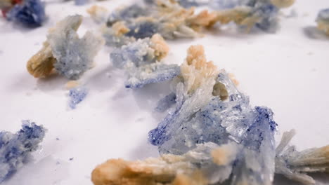 brown and purple salt crystals scattered on white table