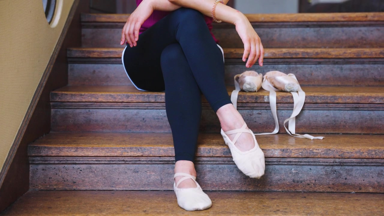Ballet Concept Shot, Woman in Tights Sitting with Pointe Shoes