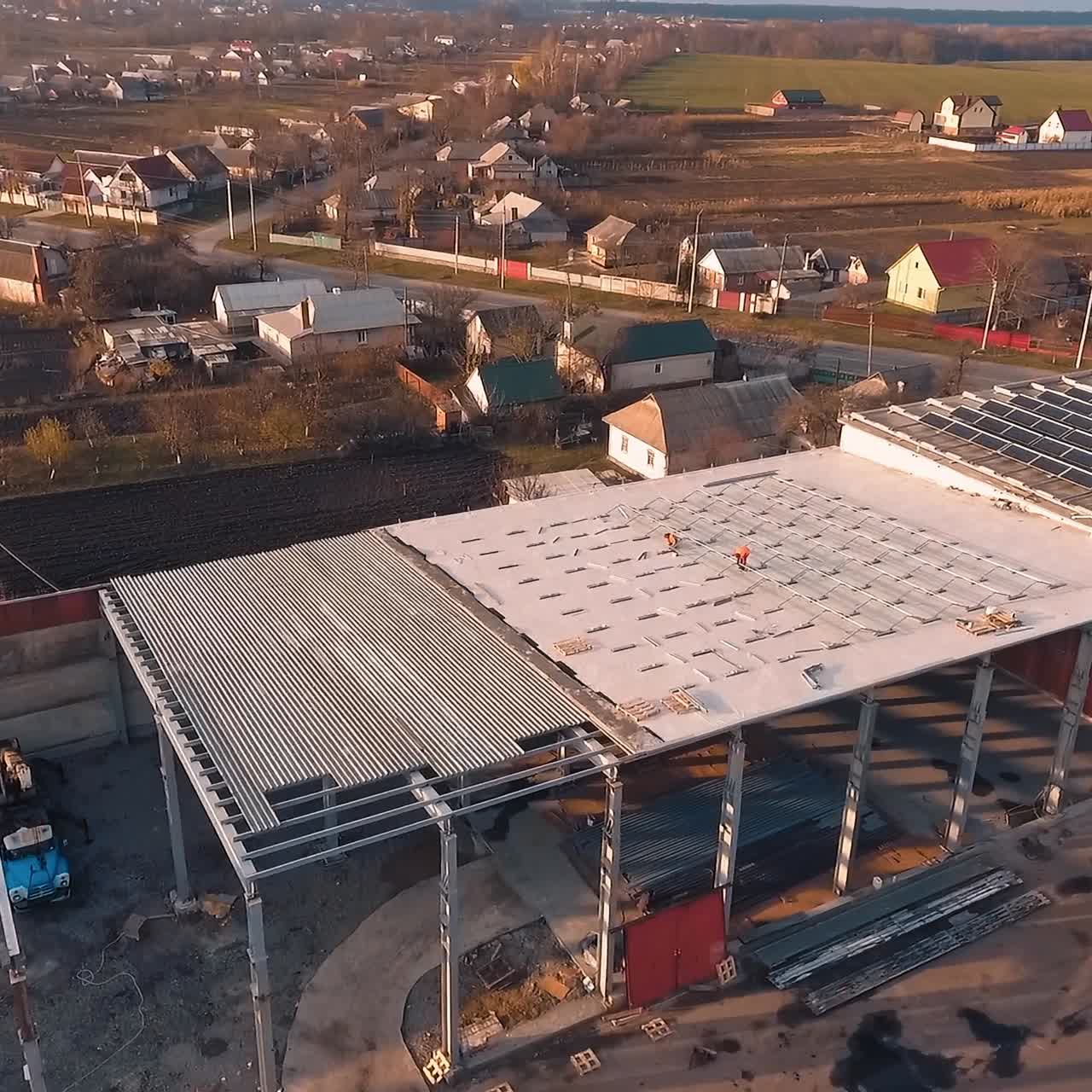 Workers on roof installing solar panels