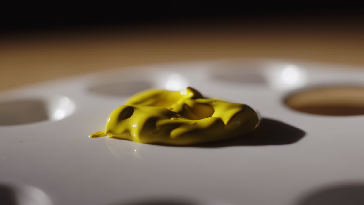 Applying Yellow Paint to a Palette