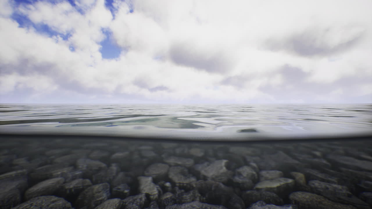 Calm water reflecting clouds above with submerged rocks below the surface
