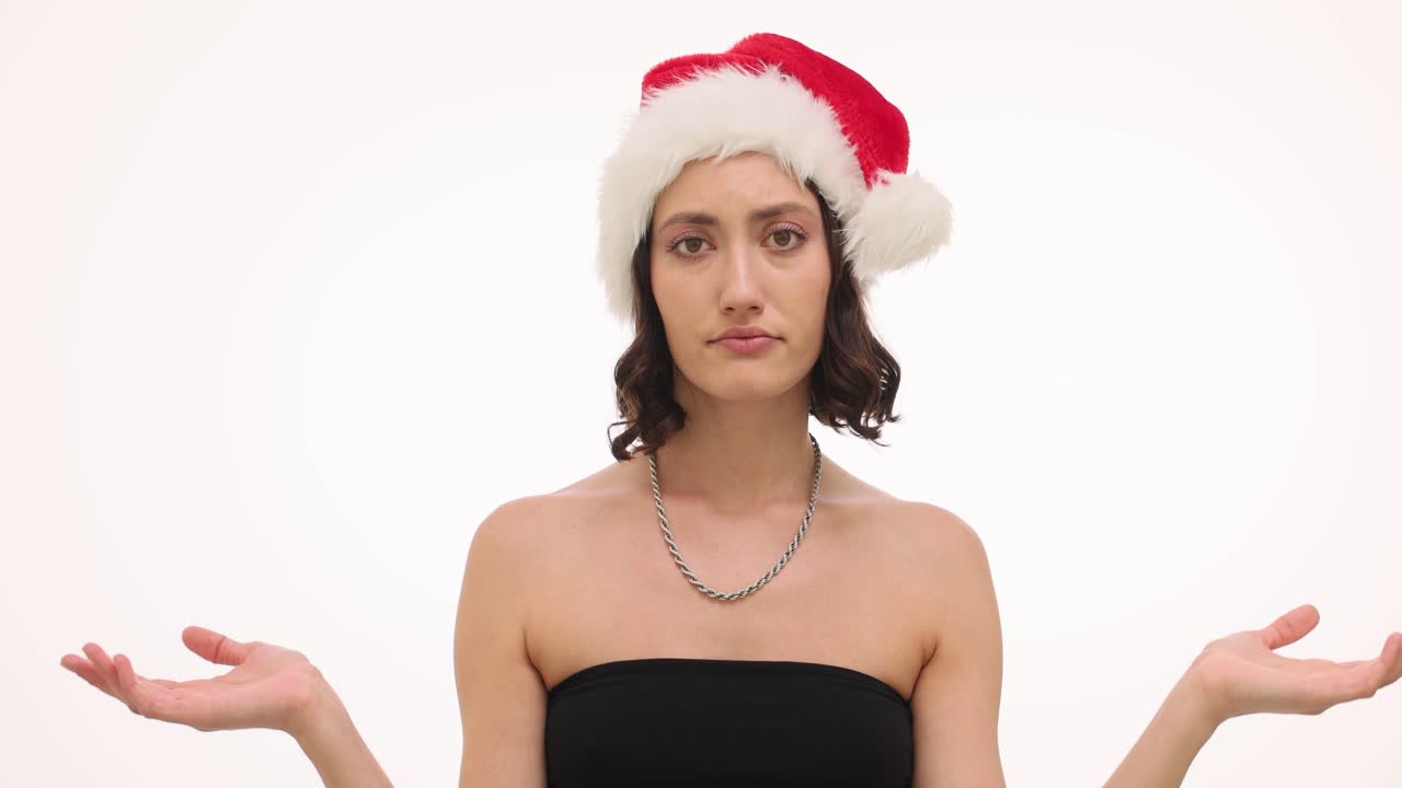 Woman in Santa hat with confused expression