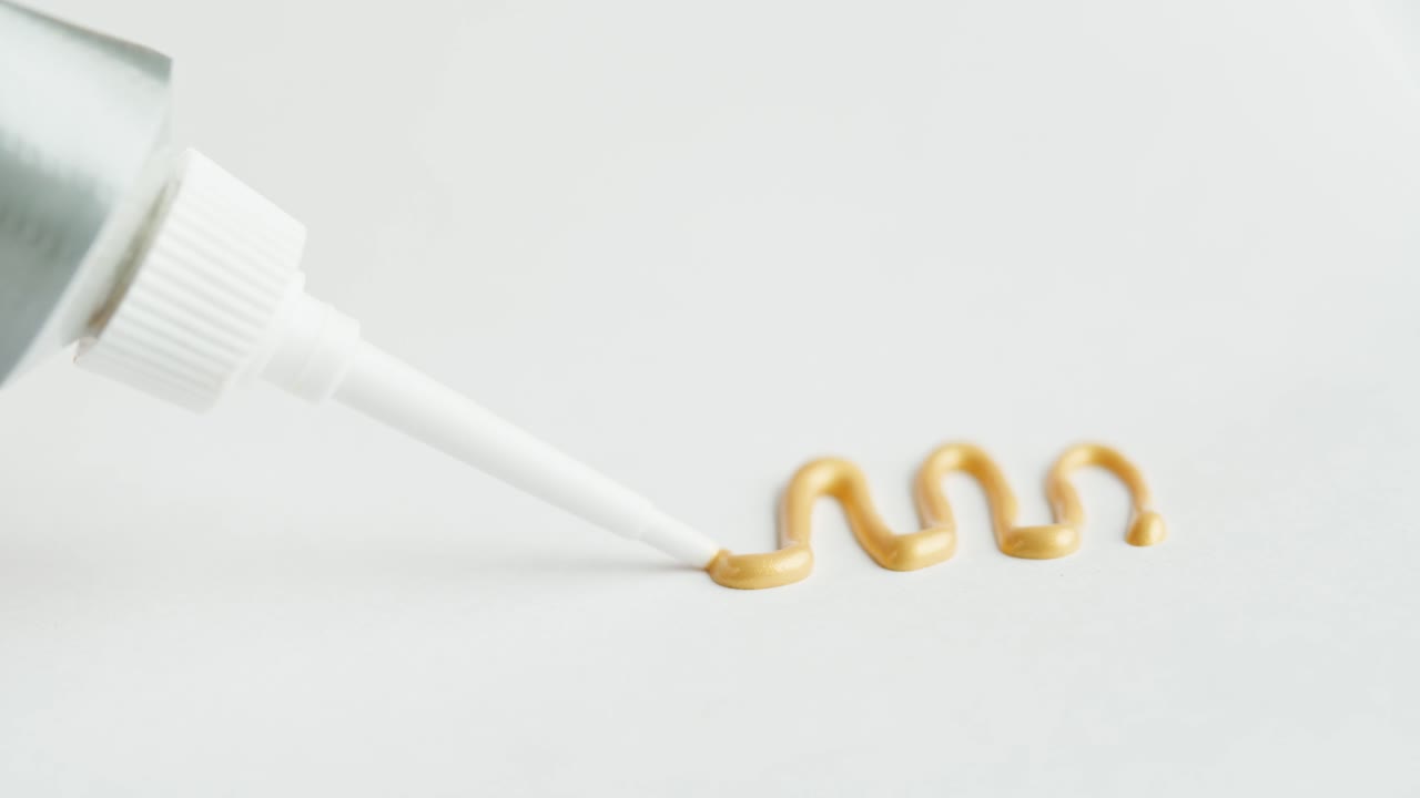 Squeezing Golden Craft Glue from a Tube