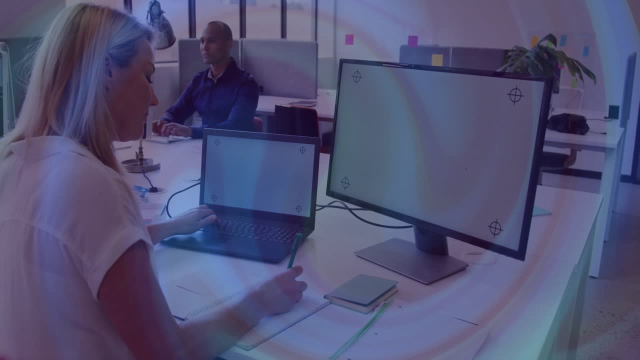 Woman opening laptop and typing at office for business report while light rings moving over monitor