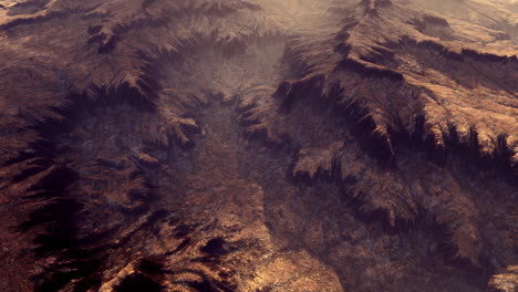 mountain terrain with deep valleys illuminated by warm sunlight at dusk