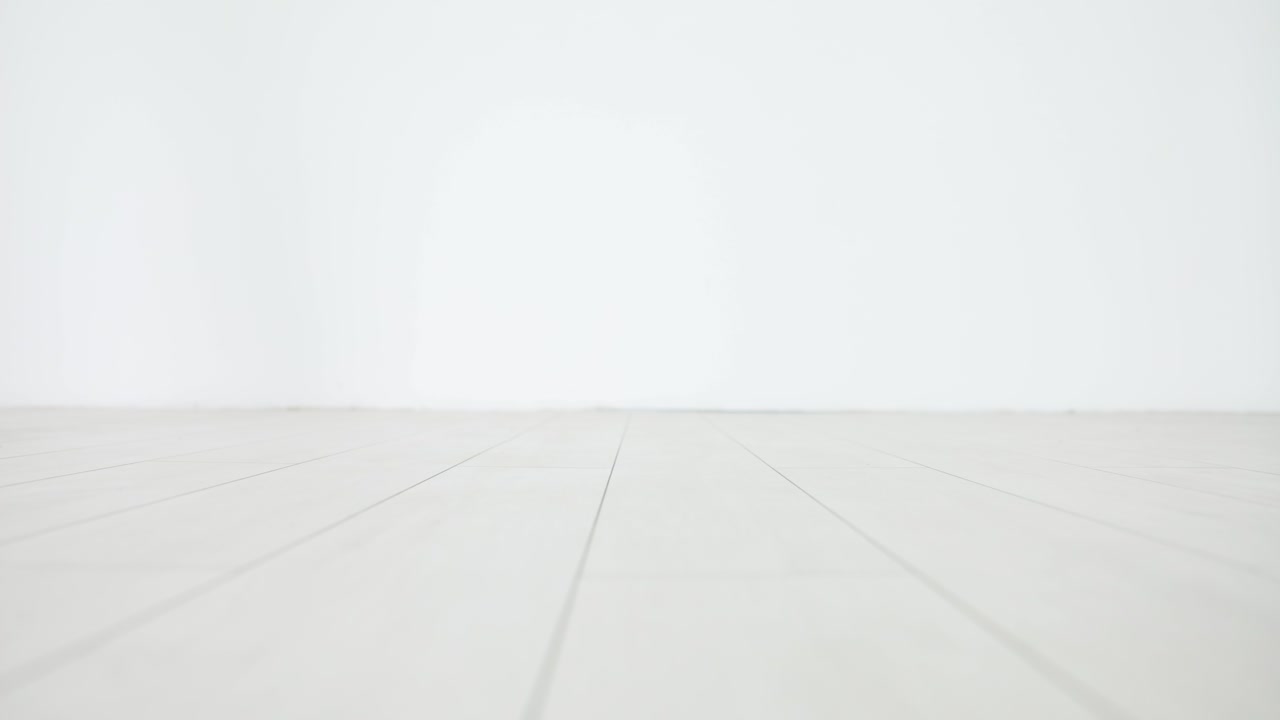 Person wearing rainbow-striped socks walking on a light-colored floor