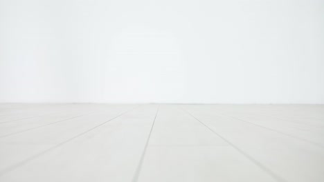 Person wearing rainbow-striped socks walking on a light-colored floor