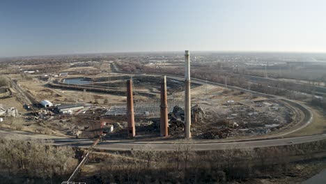 drone shot of demolished coal power plant with smoke stacks