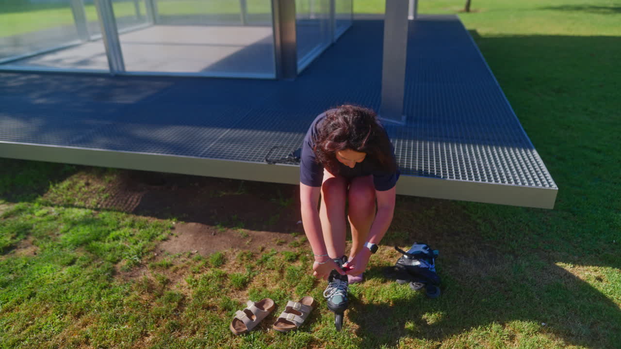 Woman preparing to roller skate in a park