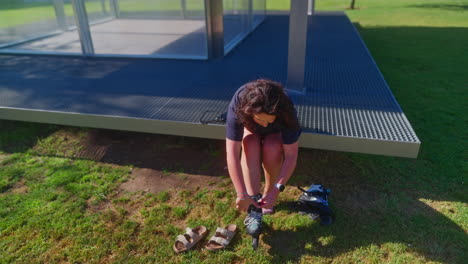 woman preparing to roller skate in a park