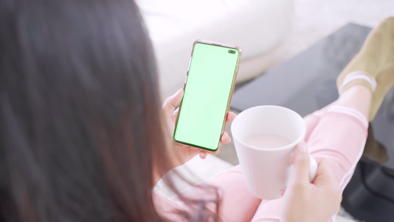 Unknown woman using smartphone with blank screen