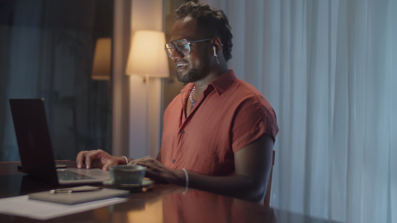 Man Video Calling on Laptop at Home in Evening