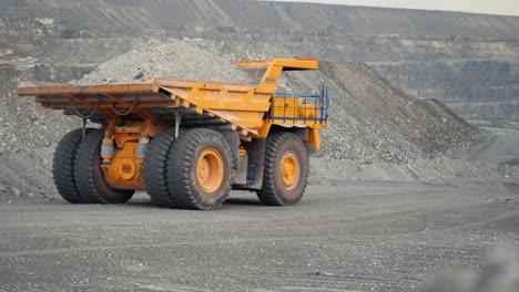 large mining truck carrying a load in an open pit mine