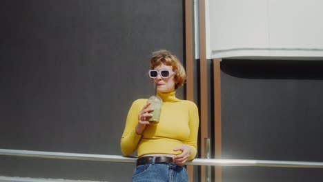 woman enjoying a smoothie in the city