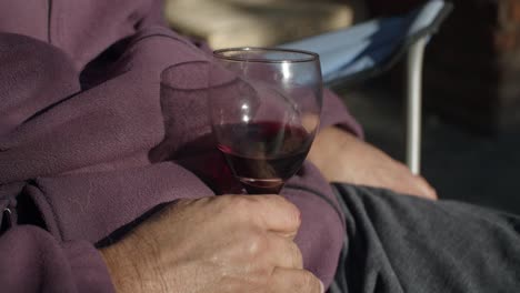 4k at 60fps (slow motion) - relaxed man at home drinking wine on a sunny day - relax and warm mood