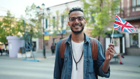 smiling man with a british flag