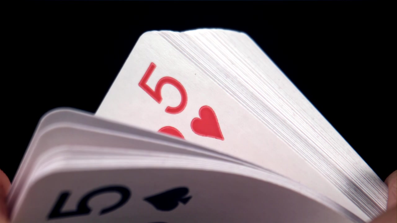Close-up of Playing Cards Being Fanned on Black Background