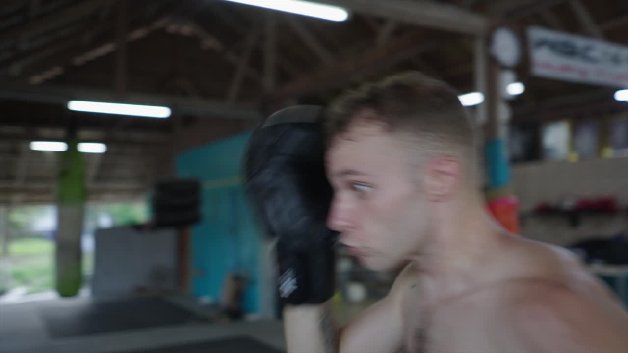 Man Training Muay Thai and Boxing in a Gym