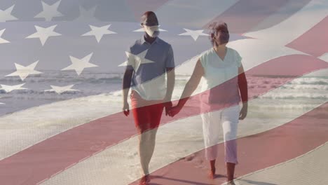 animation of flag of usa over happy senior biracial couple in love walking on beach