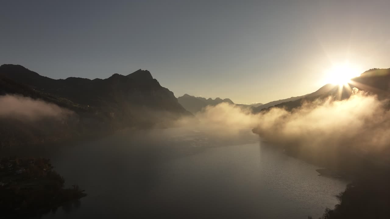 Sunrise over a misty lake in the mountains
