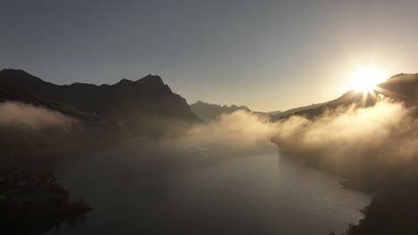 sunrise over a misty lake in the mountains