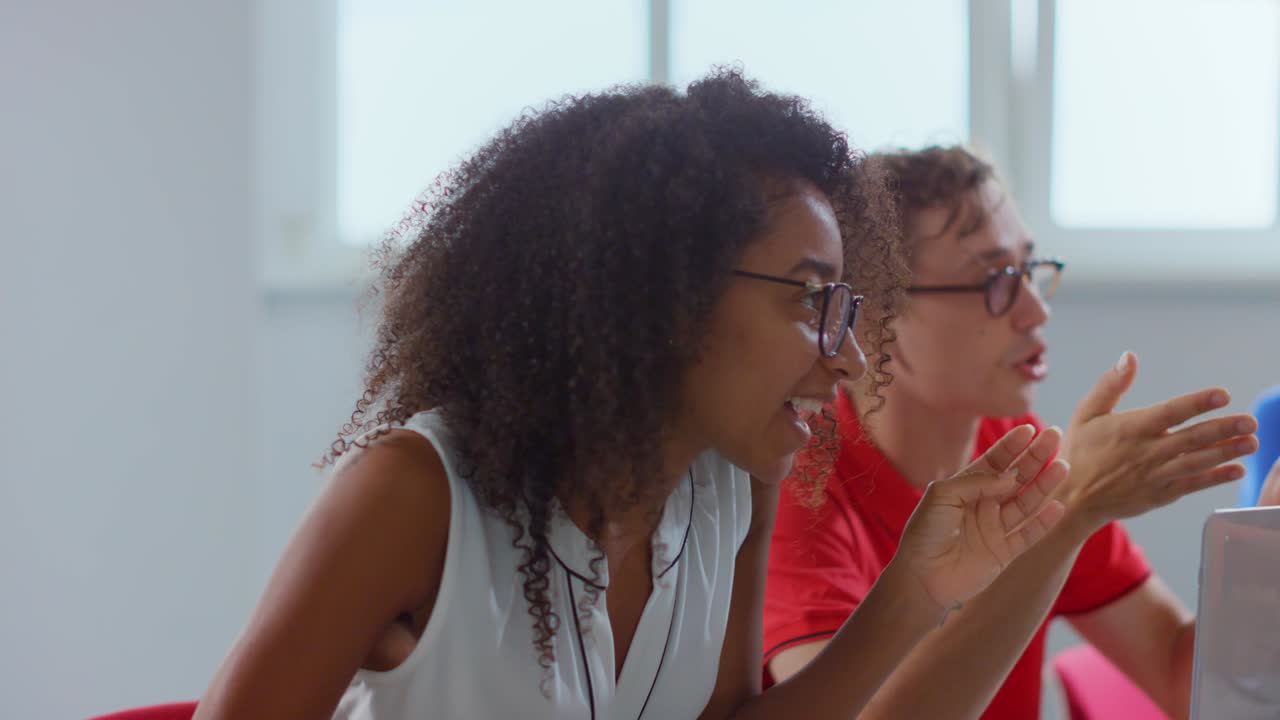 African businesswoman arguing with colleagues in meeting room