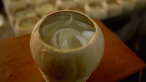 Coco-Jelly-in-a-coconut-shell,-with-coconut-water-jelly-and-roasted-coconut-pulp,-traditional-thailand-street-food