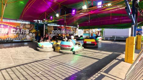 people enjoying bumper cars at a fun fair