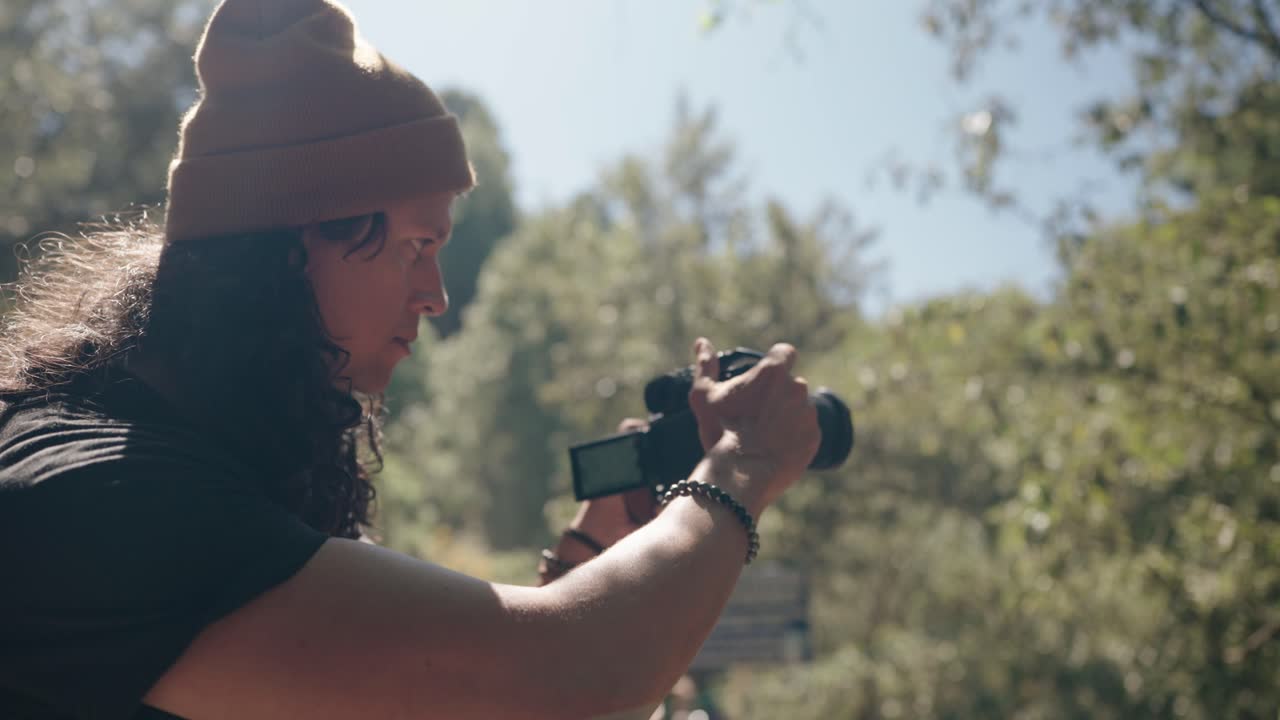 Filmmaker recording during Acatenango Volcano hike in forest light