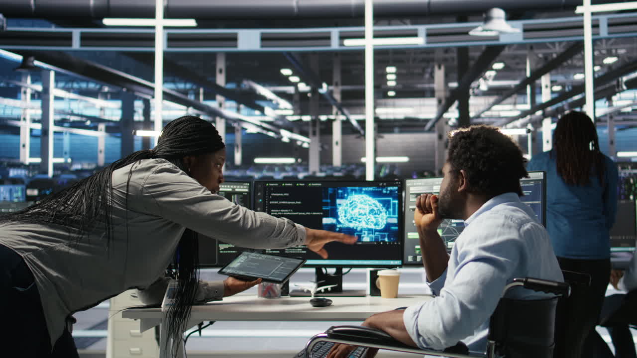 Admin in wheelchair and data center coworker work together using node tree tool