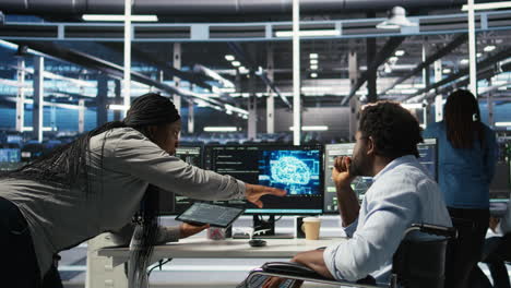 admin in wheelchair and data center coworker work together using node tree tool