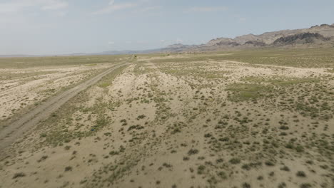 expedition jeep driving on dirt road in arid steppe plain in georgia