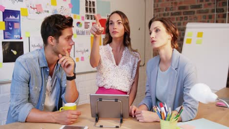 Group-of-business-executives-interacting-over-digital-tablet