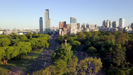 aerial revealing buenos aires skyline and bosques de palermo from behind a tree