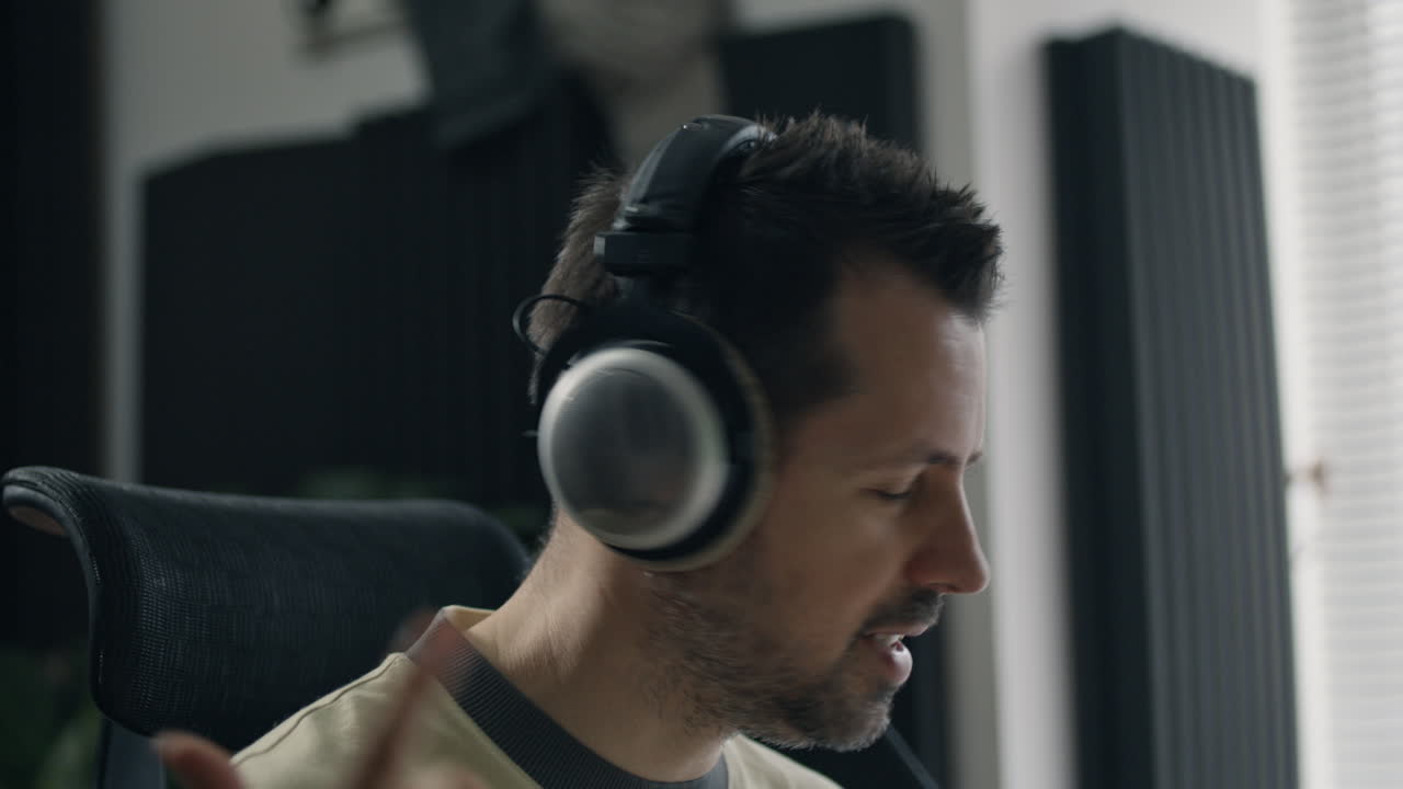 Man listening to music with headphones in a recording studio