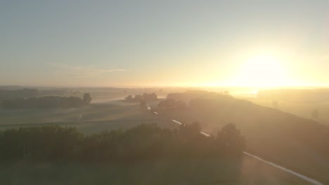 misty sunrise over dutch farmland