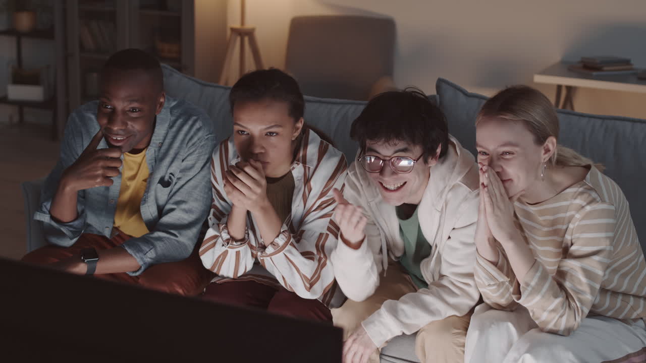 Friends Watching Fascinating Movie at Home