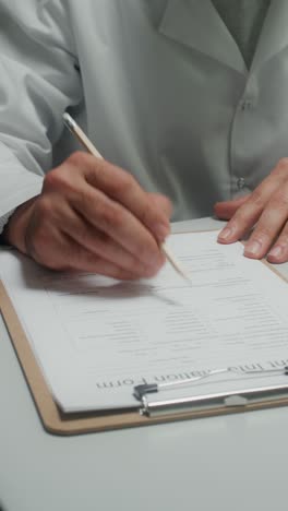 médico que llena el formulario médico del paciente