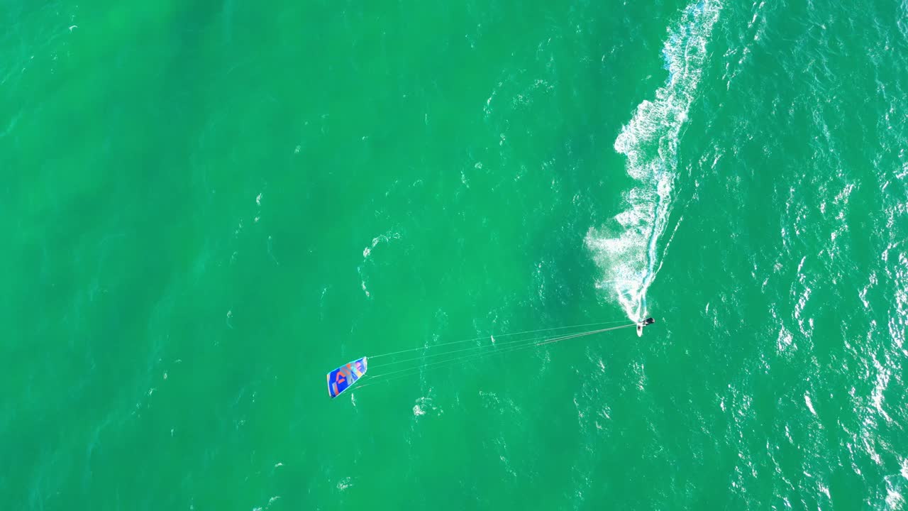 Bird's eye view of a kitesurfer riding fast in the seas of Cascais,Portugal